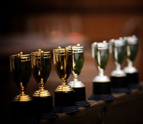 Photograph of trophies, representing college rankings